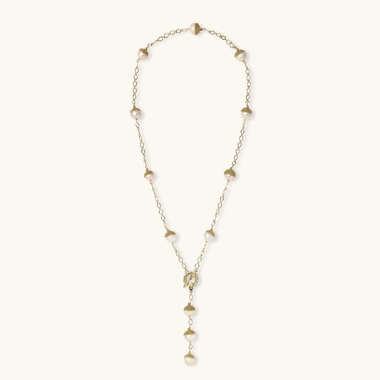 Close-up of baroque pearl station necklace with textured gold caps